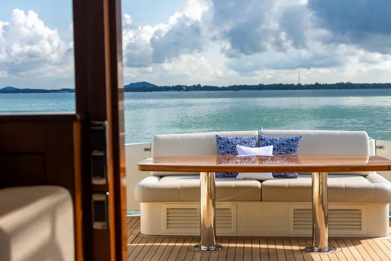Slide: The Image of Luxurious 2021 Palm Beach Motor Yachts PB65 with elegant outdoor seating and scenic ocean view. - 8