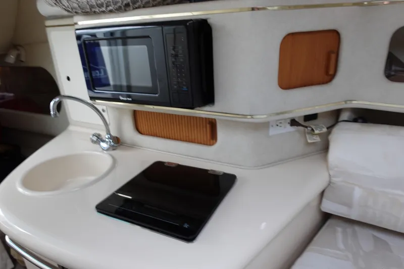 Slide: The Image of Interior of a 1997 Sea Ray 270 Sundancer with kitchenette, sink, and microwave. - 13