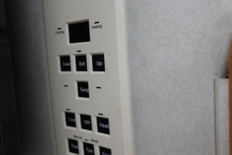 Slide: The Image of Control panel on a 1997 Sea Ray 270 Sundancer boat, featuring temperature settings. - 15