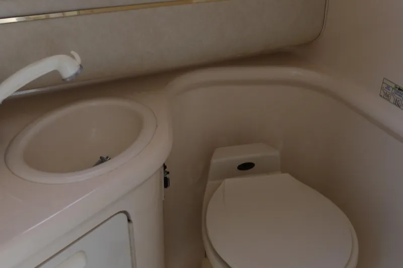 Slide: The Image of 1997 Sea Ray 270 Sundancer bathroom with sink and toilet. - 16