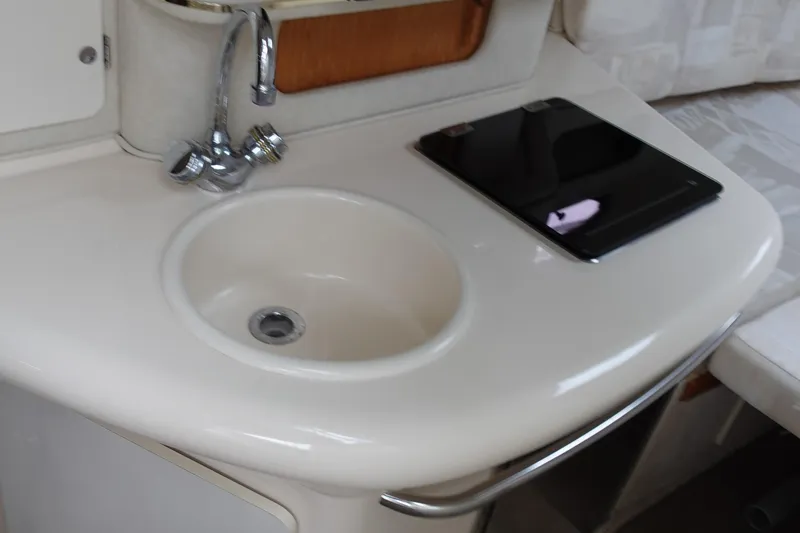 Slide: The Image of 1997 Sea Ray 270 Sundancer interior sink and counter with faucet and tablet. - 17