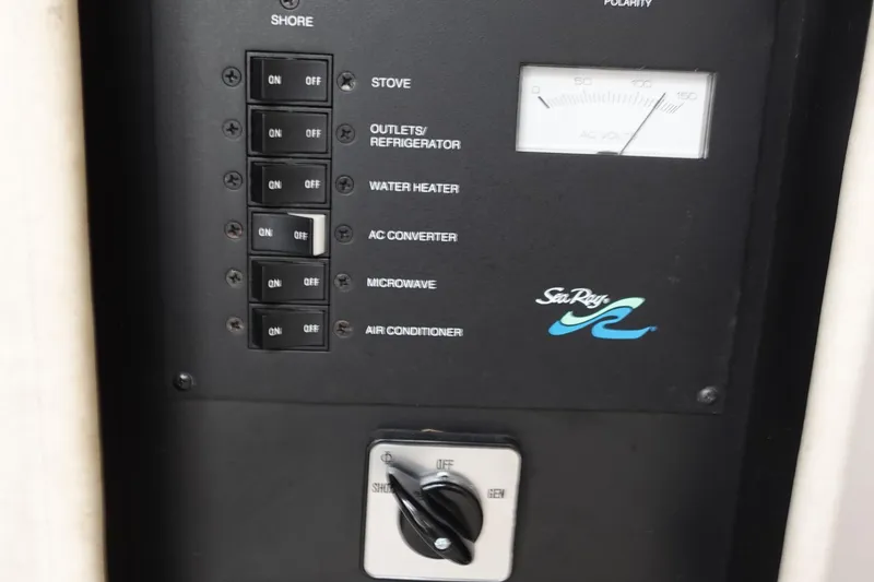 Slide: The Image of Electrical control panel of 1997 Sea Ray 270 Sundancer boat with switches and meter. - 19