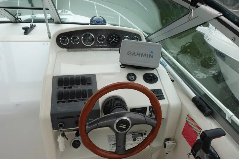 Slide: The Image of 1997 Sea Ray 270 Sundancer helm with Garmin GPS, gauges, and wooden steering wheel. - 5