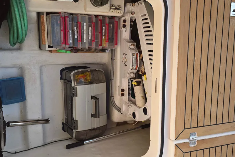 Slide: The Image of Storage compartment of a 2003 Riviera 48 Flybridge with tools and equipment. - 10