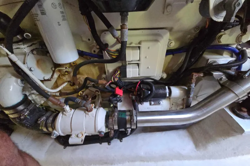 Slide: The Image of Engine compartment of a 2003 Riviera 48 Flybridge yacht, showcasing mechanical components. - 16