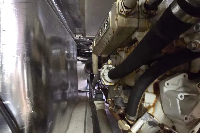 Slide: The Image of Engine room of a 2003 Riviera 48 Flybridge yacht, showcasing mechanical components. - 19