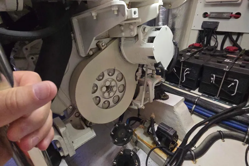 Slide: The Image of Engine room of 2003 Riviera 48 Flybridge yacht with visible components and batteries. - 24