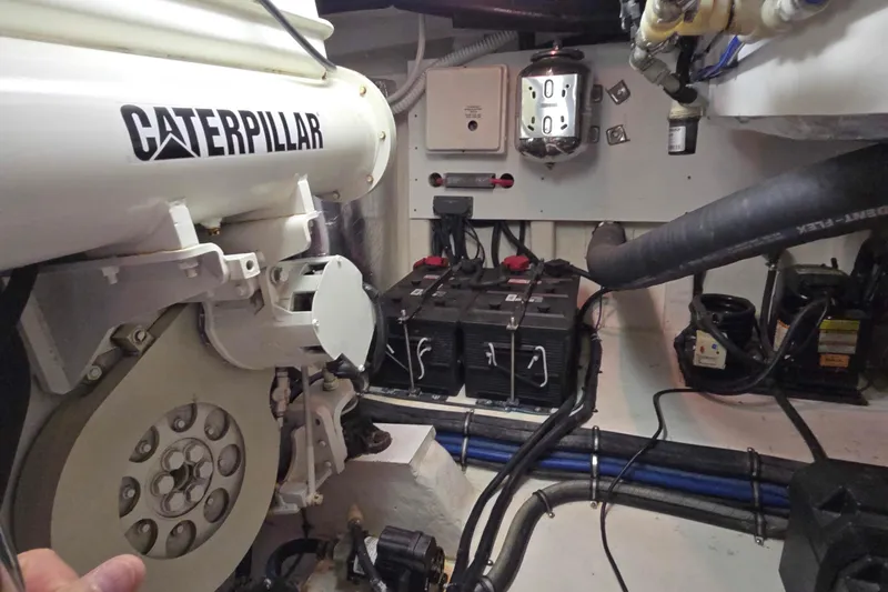 Slide: The Image of Engine room of 2003 Riviera 48 Flybridge with Caterpillar components and battery setup. - 26