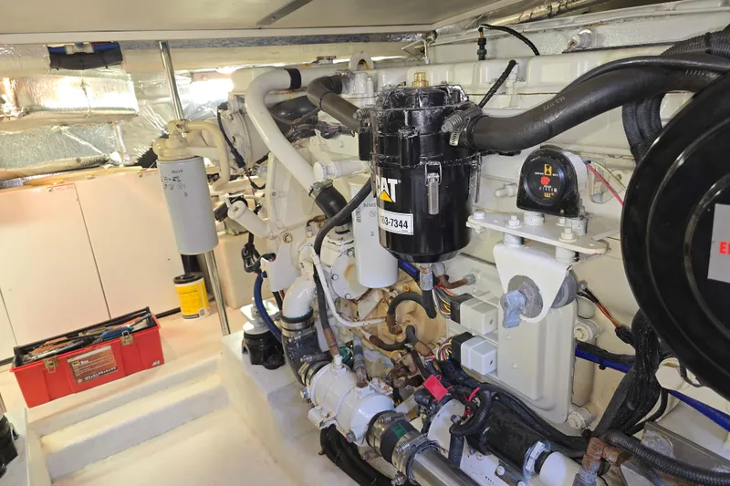 Slide: The Image of Engine room of 2003 Riviera 48 Flybridge yacht, featuring CAT machinery and organized components. - 32