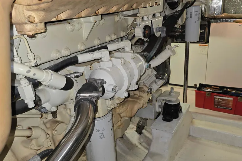 Slide: The Image of Engine room of 2003 Riviera 48 Flybridge yacht, showcasing mechanical components and tools. - 33