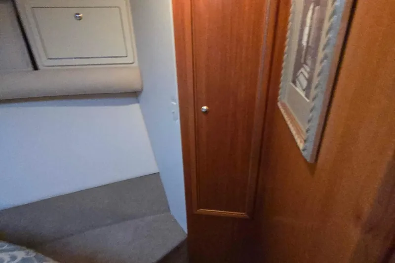 Slide: The Image of Interior of 2003 Riviera 48 Flybridge yacht with wood paneling and storage. - 40