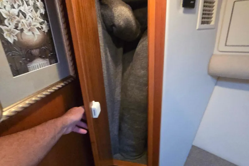 Slide: The Image of Opening a wooden cabinet on a 2003 Riviera 48 Flybridge yacht. - 42