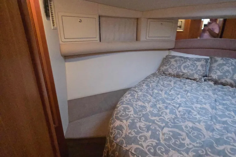 Slide: The Image of Cozy bedroom interior of 2003 Riviera 48 Flybridge yacht with patterned bedding. - 44
