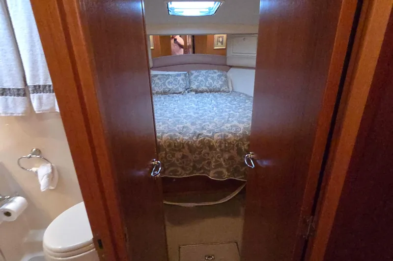 Slide: The Image of Cozy bedroom and bathroom in 2003 Riviera 48 Flybridge yacht interior. - 45