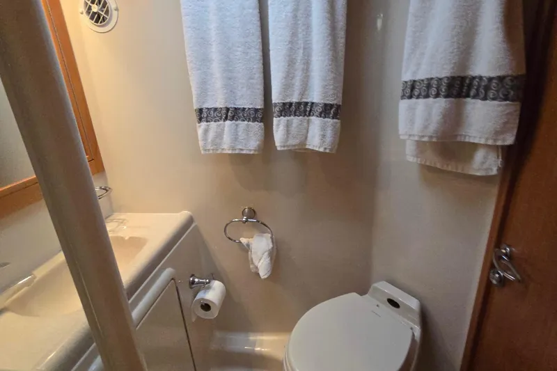 Slide: The Image of Bathroom interior of 2003 Riviera 48 Flybridge yacht with towels and toilet. - 47