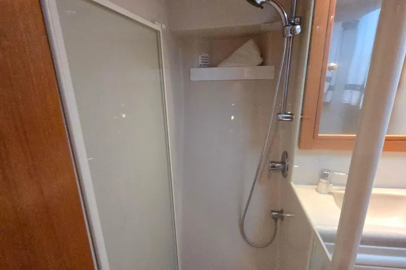 Slide: The Image of Shower area in 2003 Riviera 48 Flybridge yacht bathroom with modern fixtures. - 49