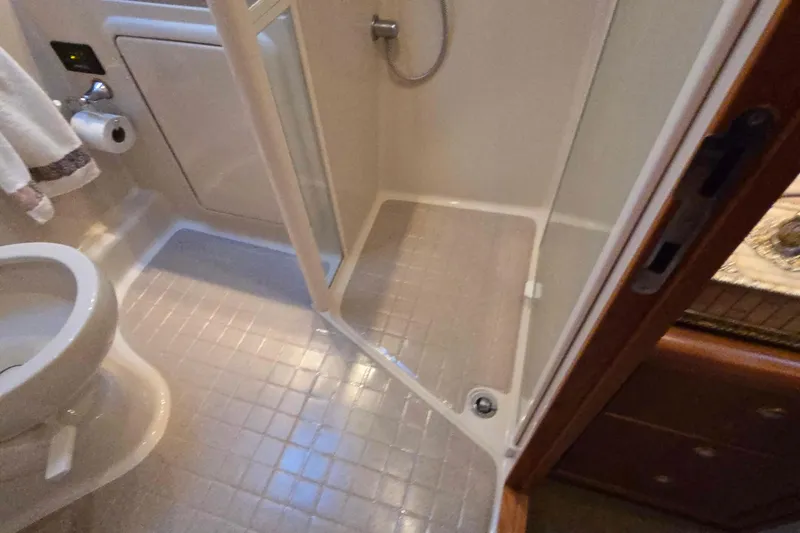 Slide: The Image of Bathroom interior of 2003 Riviera 48 Flybridge yacht, featuring shower and toilet. - 51