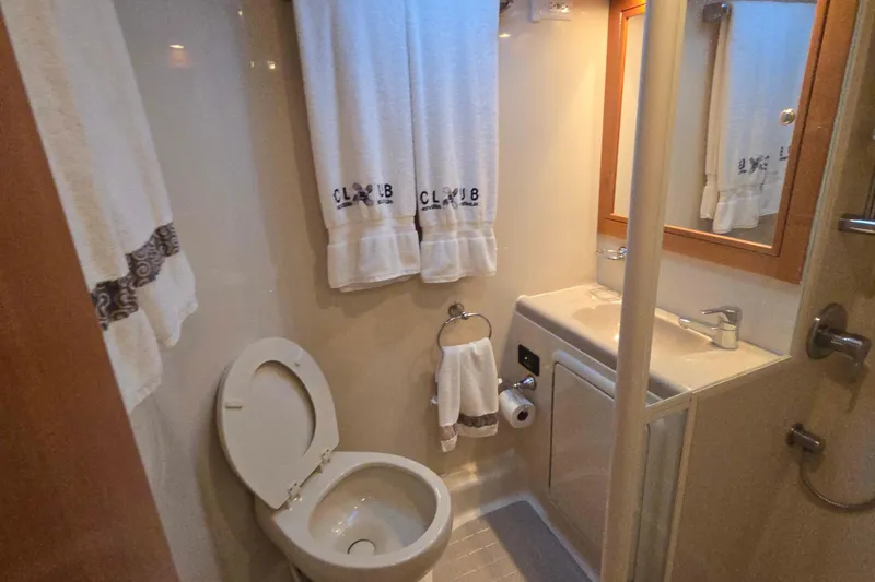 Slide: The Image of Bathroom interior of 2003 Riviera 48 Flybridge yacht with sink and toilet. - 54