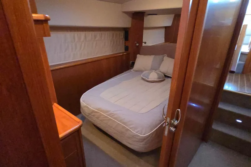 Slide: The Image of Luxurious bedroom interior of 2003 Riviera 48 Flybridge yacht with cozy bedding. - 57