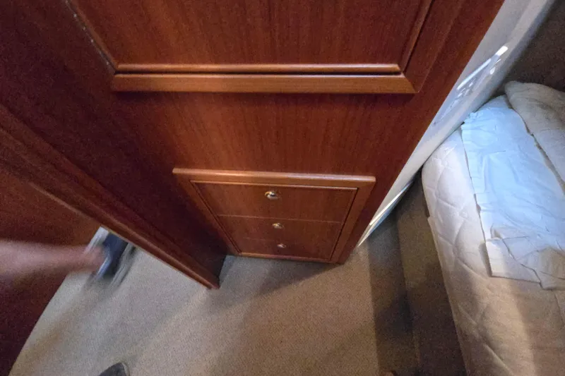 Slide: The Image of Interior of 2003 Riviera 48 Flybridge with wooden cabinetry and carpeted flooring. - 61