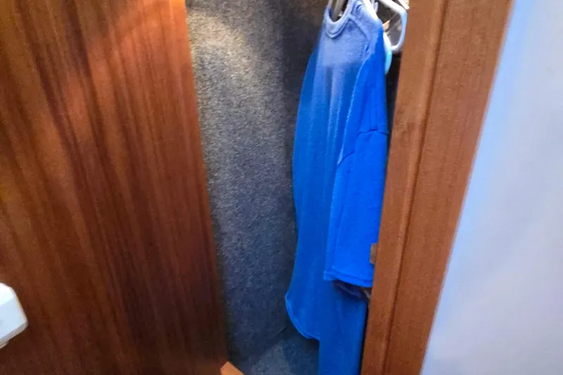 Slide: The Image of Closet interior of 2003 Riviera 48 Flybridge with blue shirts hanging. - 62