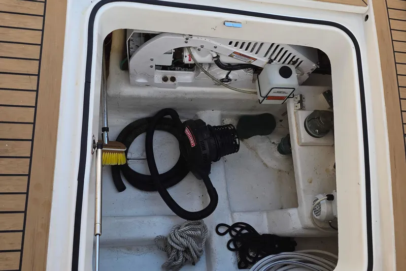 Slide: The Image of Storage compartment of a 2003 Riviera 48 Flybridge boat with equipment and tools. - 9