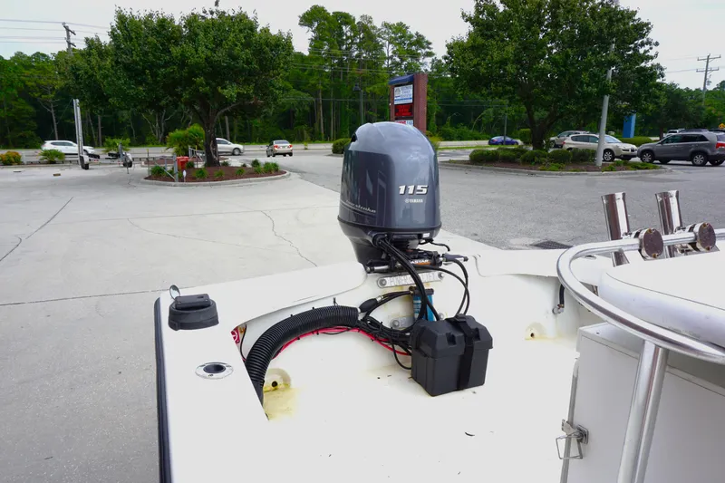 Slide: The Image of 2005 Twin Vee 19 boat with Yamaha 115 outboard motor in a parking lot. - 12