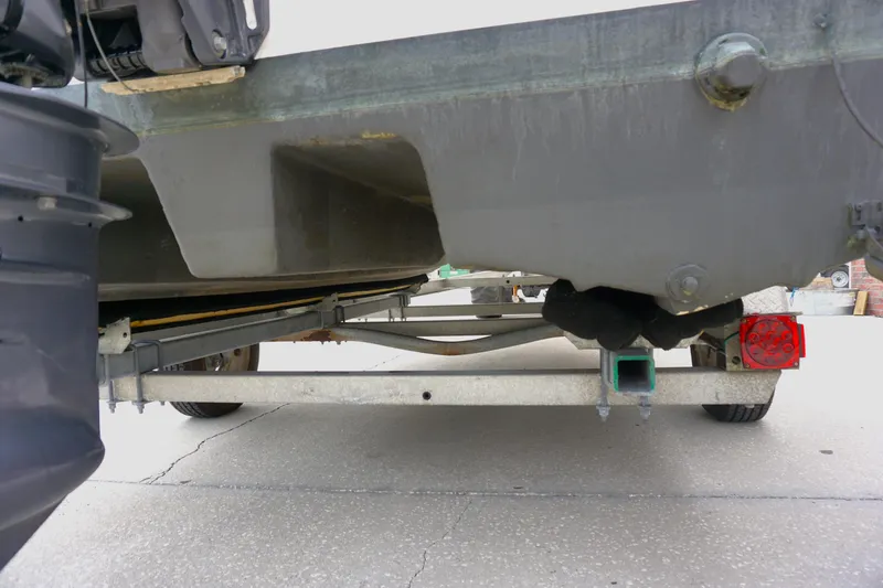 Slide: The Image of 2005 Twin Vee 19 boat on trailer, showing undercarriage and rear view. - 18