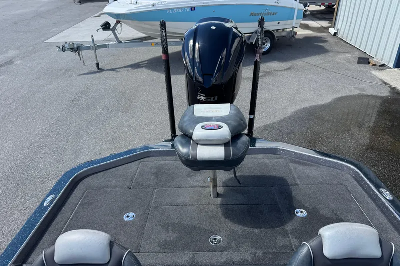 Slide: The Image of 2014 Ranger 520C boat with motor, parked on a trailer in a marina. - 10