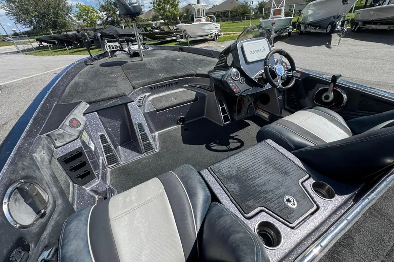 Slide: The Image of 2014 Ranger 520C boat interior with Garmin navigation system and sleek seating. - 13