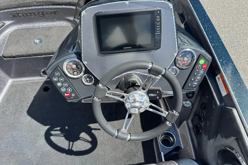 Slide: The Image of 2014 Ranger 520C boat dashboard with steering wheel and Garmin display. - 14