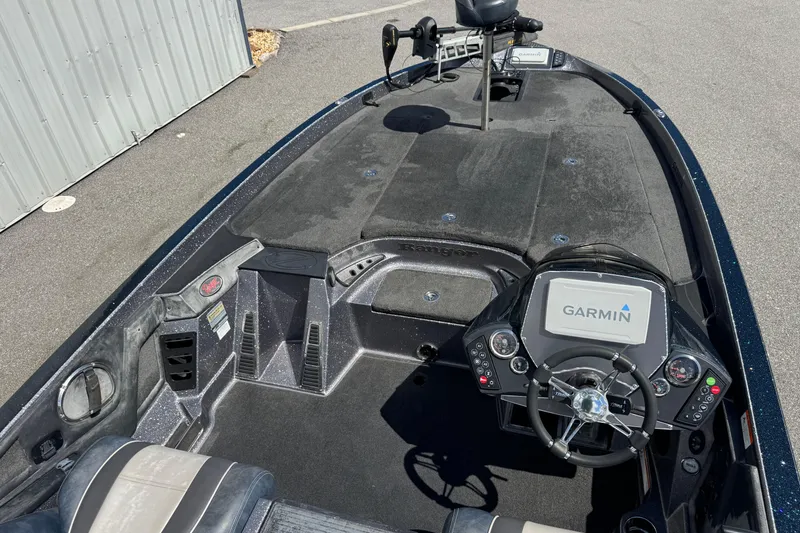 Slide: The Image of 2014 Ranger 520C boat interior with Garmin navigation system and steering console. - 15