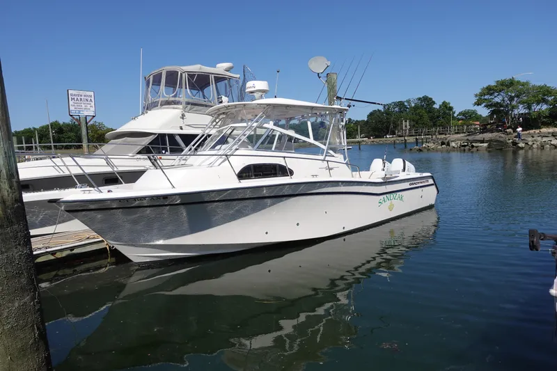 The Image of 2002 Grady White 300 Marlin boat docked at a marina on a sunny day. - 0