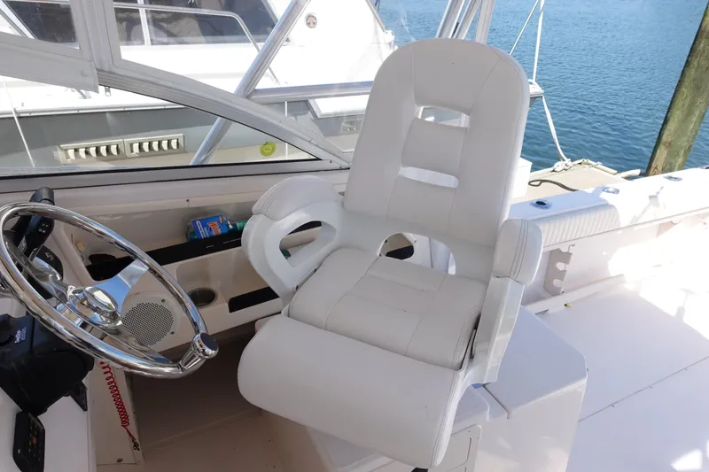 Slide: The Image of Captain's chair and steering wheel on a 2002 Grady White 300 Marlin boat. - 12
