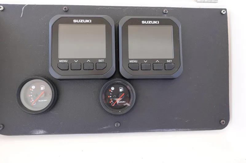 Slide: The Image of Dashboard of a 2002 Grady White 300 Marlin with Suzuki gauges and displays. - 15