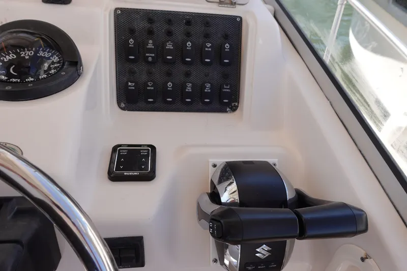 Slide: The Image of Control panel of a 2002 Grady White 300 Marlin boat with Suzuki throttle. - 16