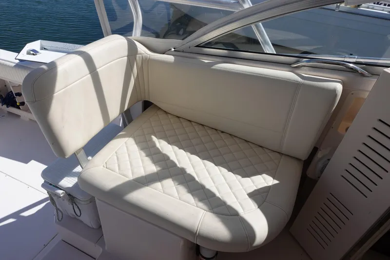 Slide: The Image of 2002 Grady White 300 Marlin boat interior with cushioned seating. - 17