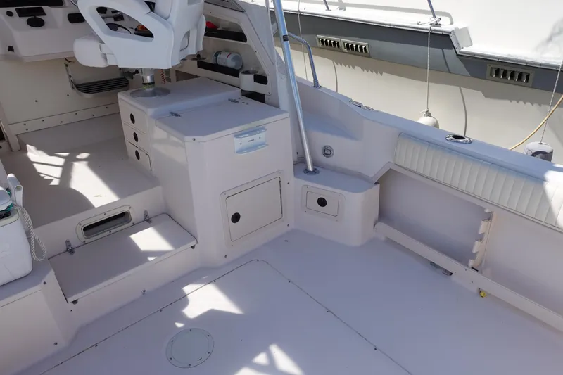 Slide: The Image of 2002 Grady White 300 Marlin boat interior, featuring seating and storage compartments. - 19