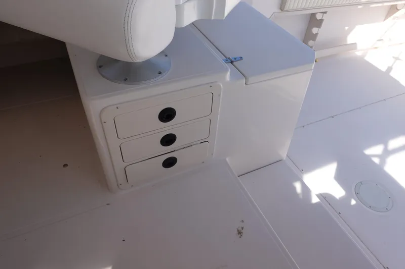 Slide: The Image of 2002 Grady White 300 Marlin boat interior with storage compartments and seating. - 21