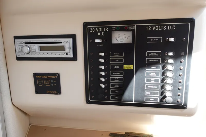 Slide: The Image of Control panel of a 2002 Grady White 300 Marlin boat with stereo and tank monitor. - 24