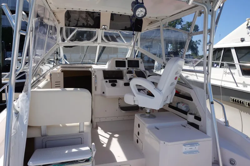 Slide: The Image of 2002 Grady White 300 Marlin boat interior with helm, seating, and navigation equipment. - 8