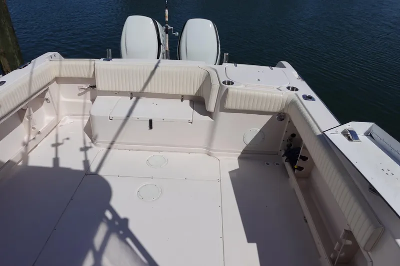 Slide: The Image of 2002 Grady White 300 Marlin boat deck with twin engines on calm water. - 9