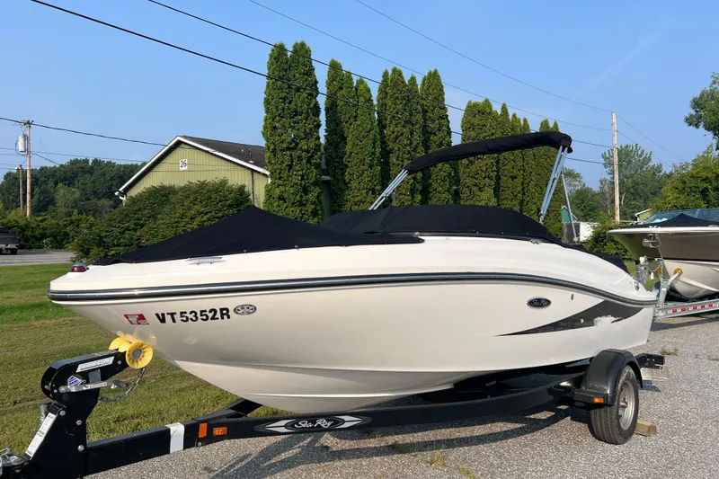 Slide: The Image of 2013 Sea Ray 190 Sport boat on trailer, parked outdoors. - 1