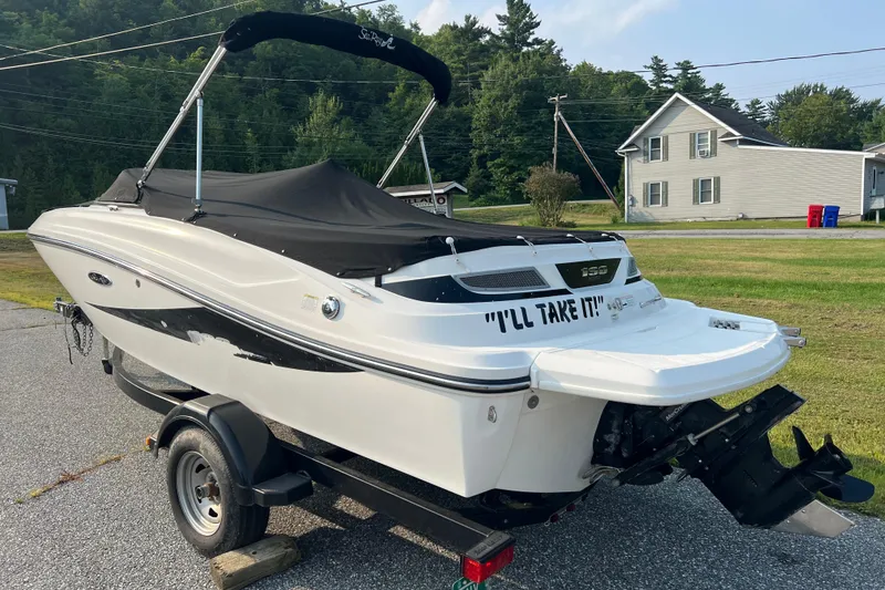Slide: The Image of 2013 Sea Ray 190 Sport boat on trailer, covered and parked outdoors. - 3