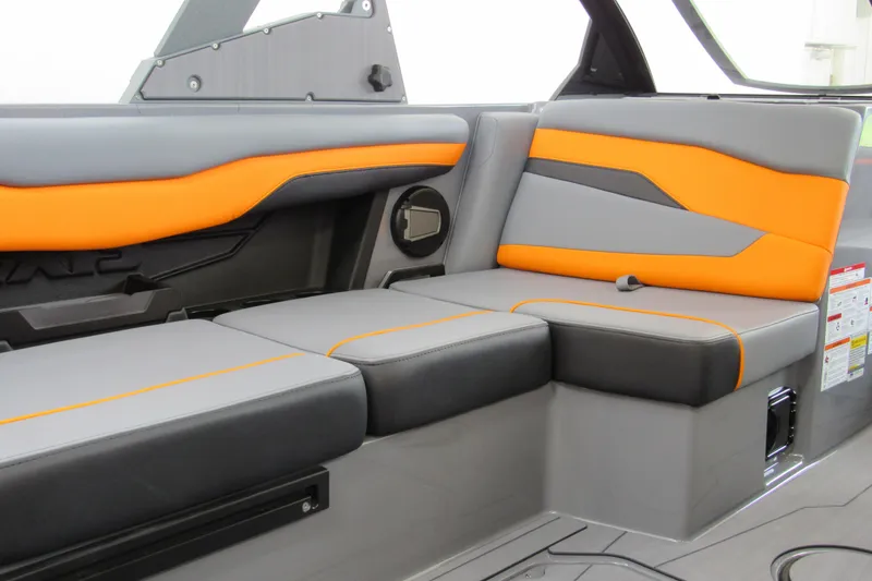 Slide: The Image of 2025 Axis T220 boat interior with gray and orange seating, modern design. - 11
