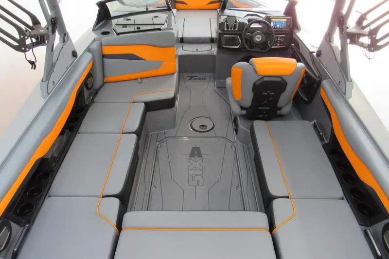 Slide: The Image of 2025 Axis T220 boat interior with gray and orange seating, modern dashboard, and spacious layout. - 4