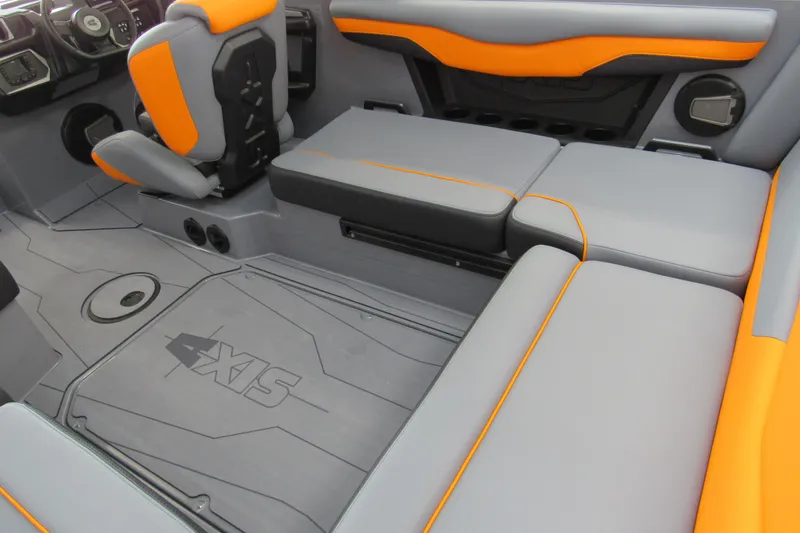 Slide: The Image of 2025 Axis T220 boat interior with gray and orange seating, modern design. - 5