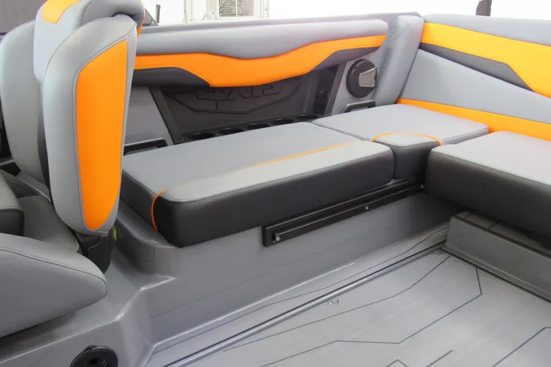 Slide: The Image of 2025 Axis T220 boat interior with gray and orange seating, modern design. - 7