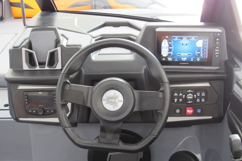 Slide: The Image of 2025 Axis T220 boat dashboard with steering wheel and Garmin display. - 8