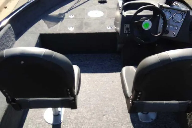 Slide: The Image of 2026 Tracker Pro Guide V-16 SC boat interior with steering wheel and seating. - 2